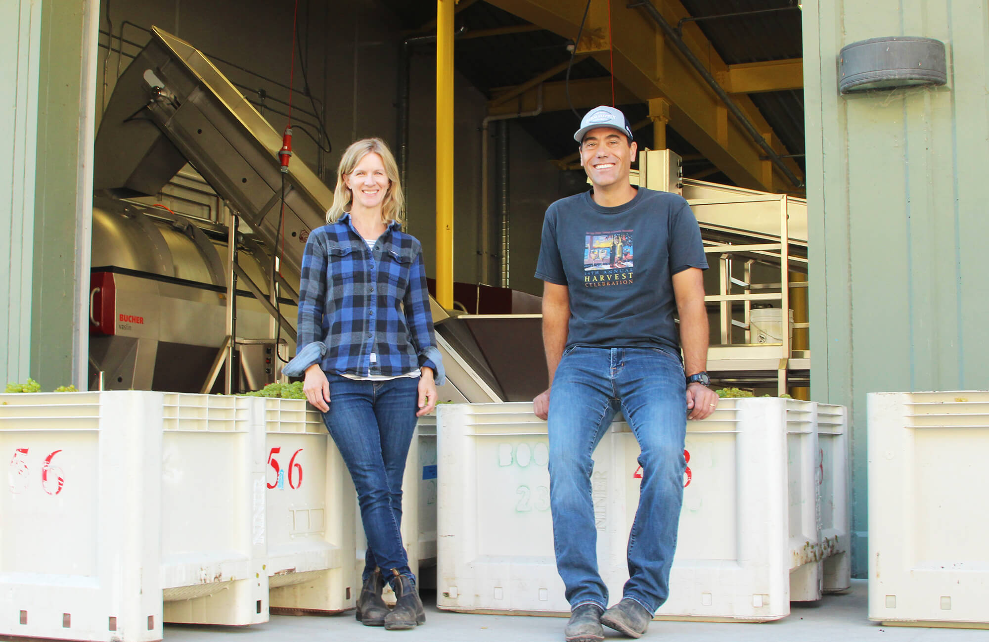 Winemakers Molly & Patrick smiling in front of the winery 