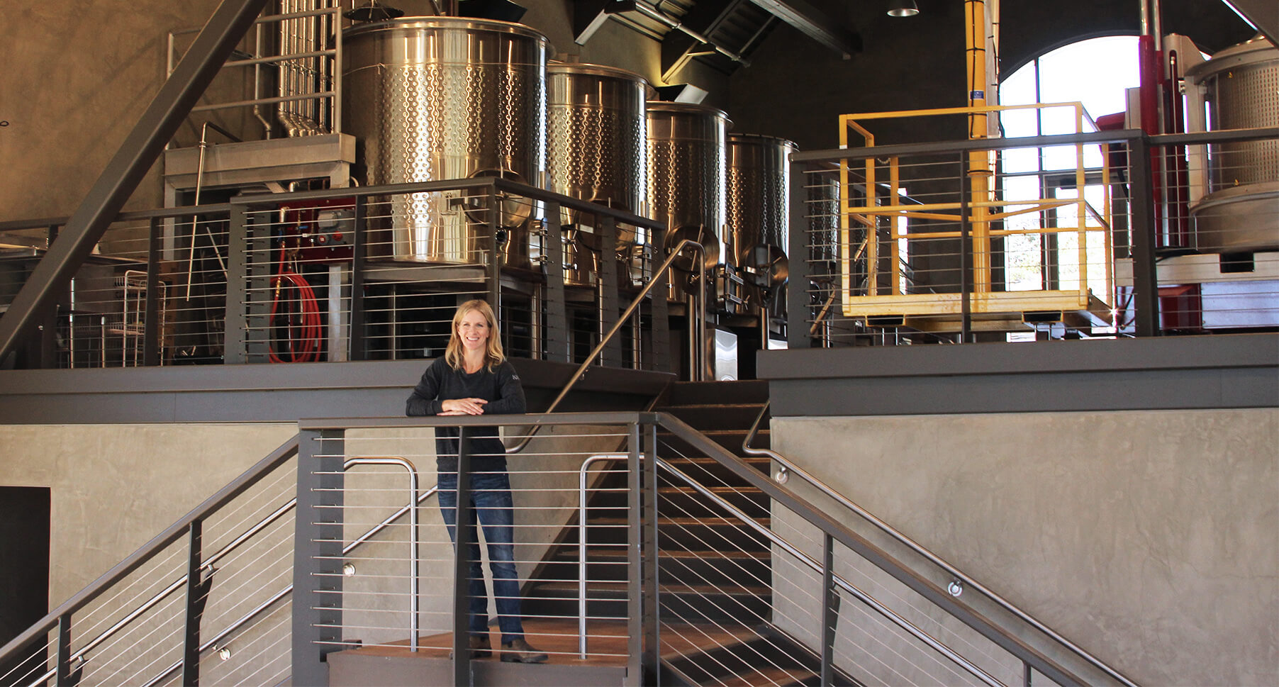 Molly standing on the stairs in our Craft Winery