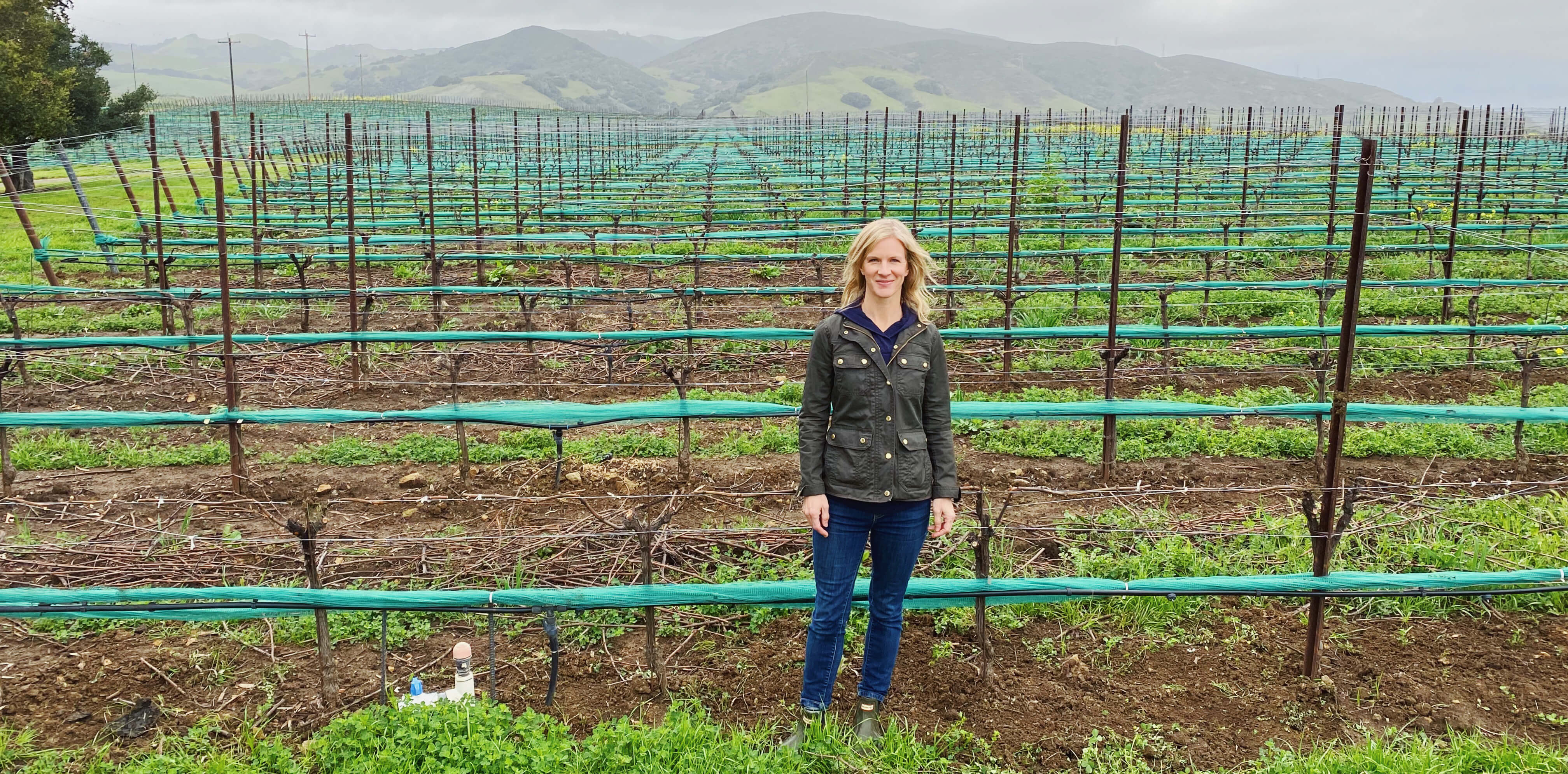 Winemaker Molly Bohlman standing in front of rows at Jespersen Ranch