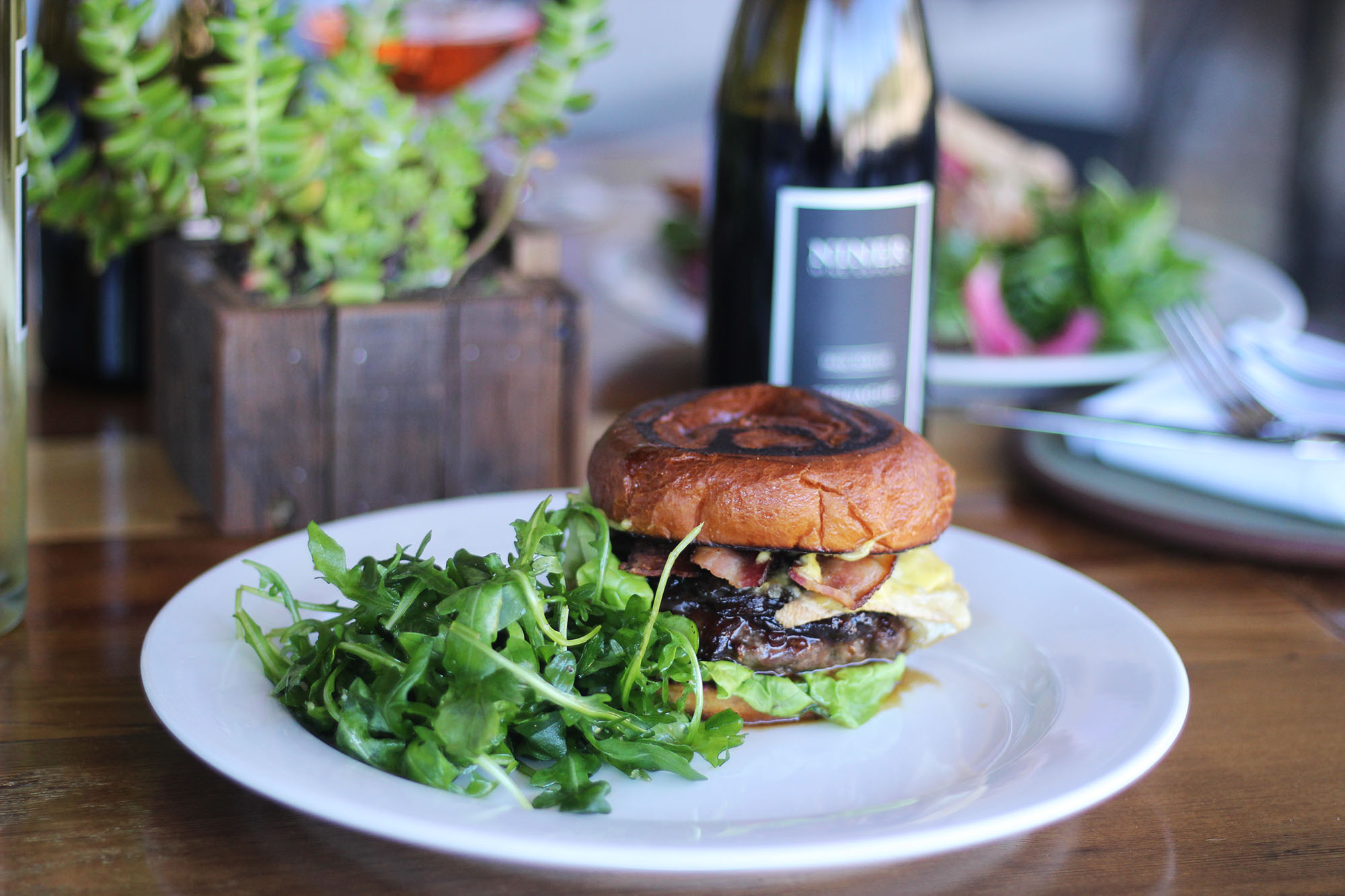 Our burger with a bed of garden greens