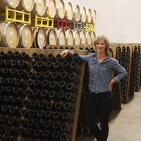 Winemaker Molly Bohlman leaning on a riddling rack 
