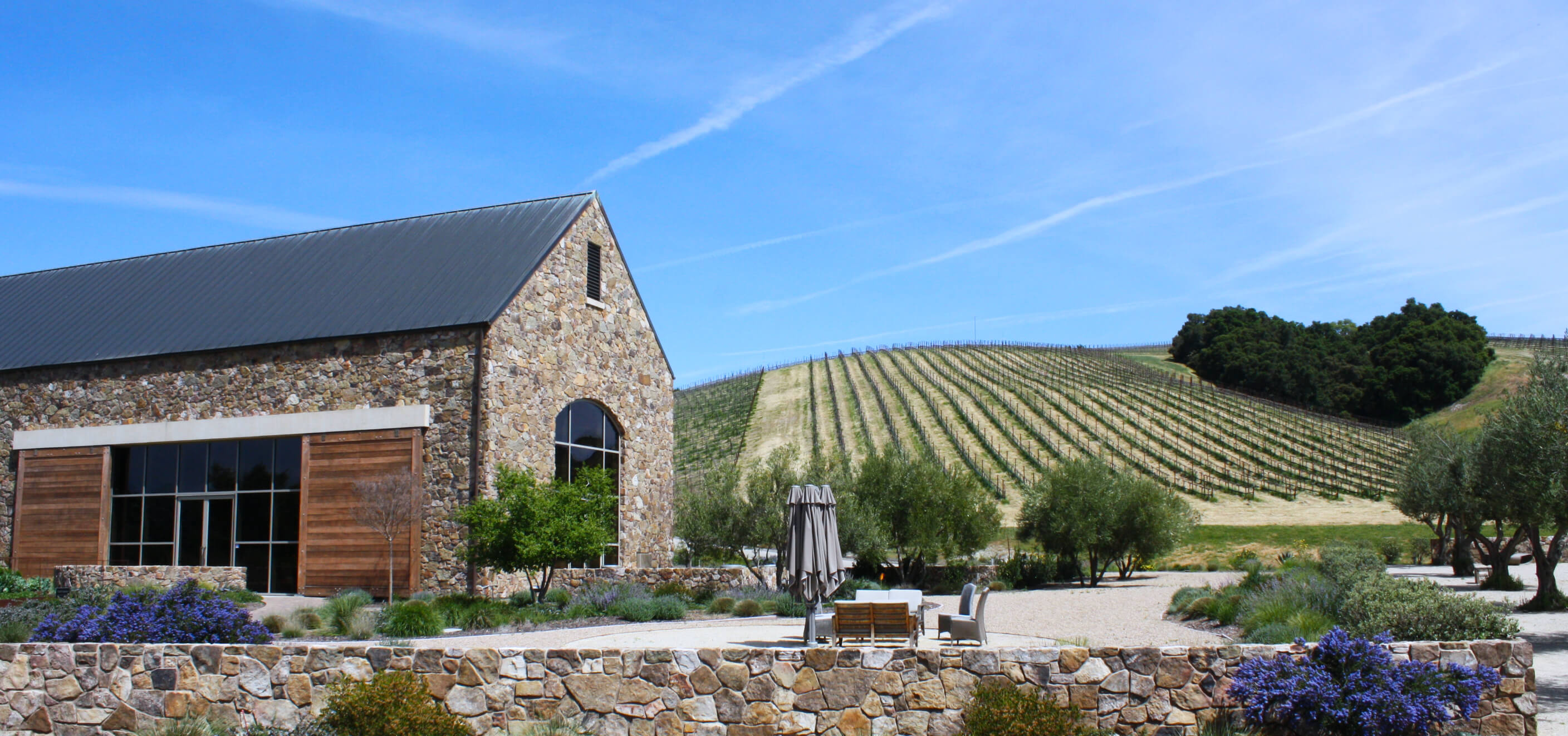 The craft winery and Heart Hill Vineyard with a blue sky in the background